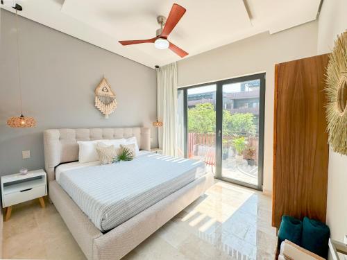 a bedroom with a bed with a ceiling fan at Stay Near The Sea HOTEL ZONE TULUM 1 Bedroom in Tulum