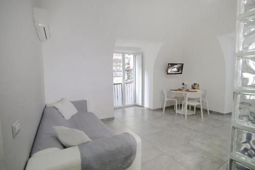 a living room with a couch and a table at Casa Sant Anna in Naples