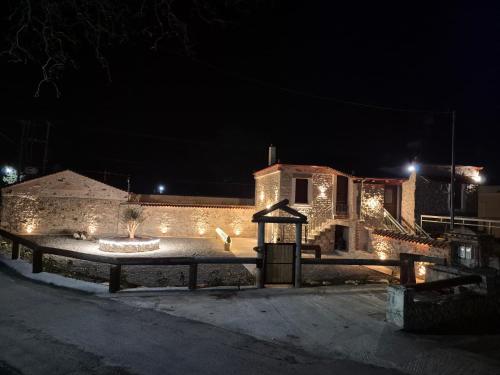 a building with lights on it at night at Olive Stone House in Alíartos