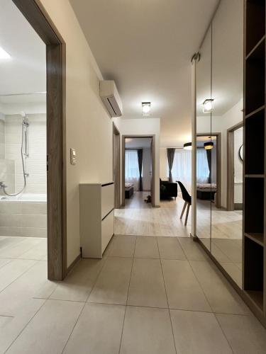 a bathroom with a walk in shower and a sink at MT Suites ApartHotel in Budapest