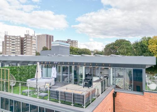 a building with a balcony with a view of the city at Luxury Penthouse with Private Hot Tub Overlooking Leeds City Centre in Leeds