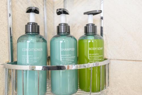 a group of three bottles of detergent on a shelf at Luxury Penthouse with Private Hot Tub Overlooking Leeds City Centre in Leeds