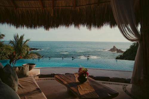 a view of the ocean from a resort with a swimming pool at ZOA Hotel - Adults Only in Mazunte