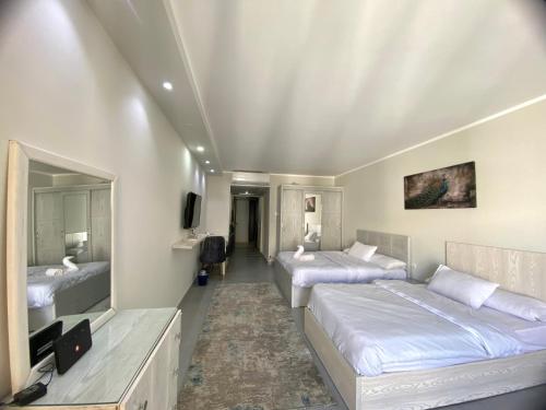 une chambre d'hôtel avec deux lits et une télévision dans l'établissement Scandic resort, à Hurghada