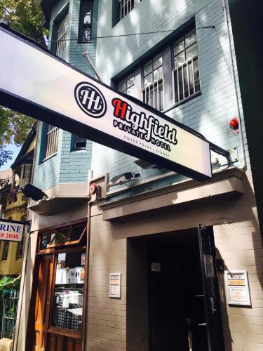 a sign for a restaurant on a building at Highfield Private Hotel in Sydney