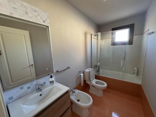 a bathroom with a sink and a toilet and a shower at La Corrala de Chite in Lecrin