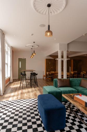 a living room with a couch and a table at Haka House Christchurch in Christchurch