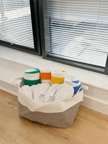a basket filled with dishes on a floor next to a window at Luxury Penthouse with Private Hot Tub Overlooking Leeds City Centre in Leeds