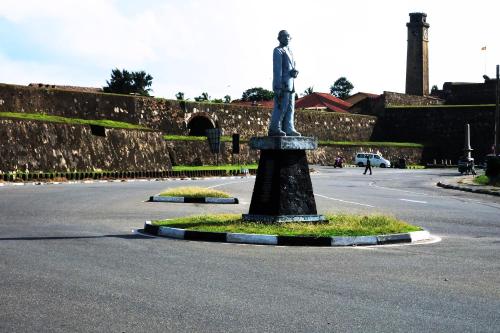 a statue sitting in the middle of a street at Orchard House Galle in Galle