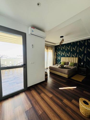 a living room with a couch and a large sliding door at sea view villa with garden in Agadir
