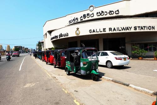 a small vehicle parked in front of a building at Orchard House Galle in Galle