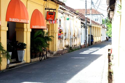 an empty street in an old town with buildings at Orchard House Galle in Galle