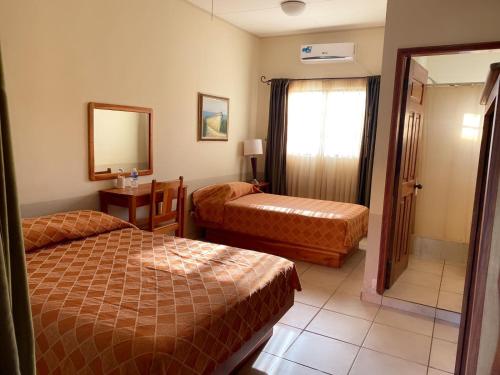 Postel nebo postele na pokoji v ubytování Hotel Playa Bonita Tela