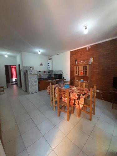 a kitchen with a table and chairs in a room at Complejo Don Tito in San Juan