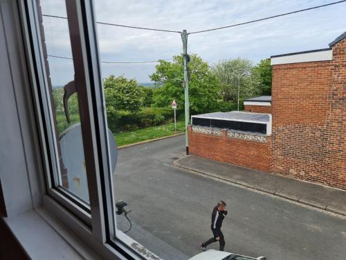 a man walking down a street seen from a window at KELVIN HOUSE in Durham