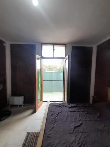 a room with a bed and a large window at Complejo Don Tito in San Juan