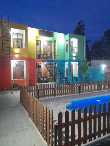 a building with a pool in front of a house at Complejo Don Tito in San Juan