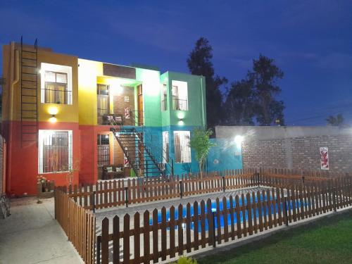 a colorful building with a fence in front of it at Complejo Don Tito in San Juan
