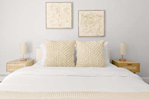 a bedroom with a white bed with two two lamps at Bright & Modern - King Suite - Creekside Trail in Boulder