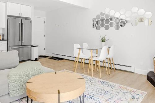 a living room with a table and chairs and a refrigerator at Bright & Modern - King Suite - Creekside Trail in Boulder