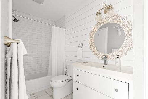a white bathroom with a sink and a mirror at Bright & Modern - King Suite - Creekside Trail in Boulder