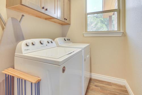 a small laundry room with a washer and dryer at Scenic Views, Fire Pit Texas Hill Country Getaway in Fischer
