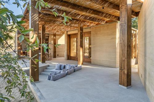 a living room of a house with a wooden ceiling at Salara in Todos Santos