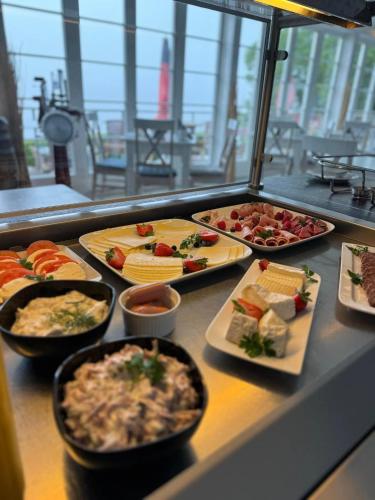 a buffet line with many different types of food at Strandhaus Edersee Nr 12 - Kaminzimmer, Seeblick, Badestrand, Seeterrasse in Waldeck