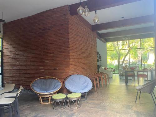 a room with chairs and a brick wall at Casa NOGAL in Santa María del Oro