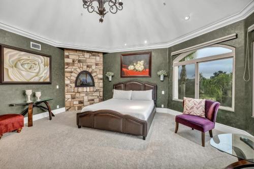 a bedroom with a bed and a purple chair at Secluded Boulder Groves Resort Getaway! in Ramona