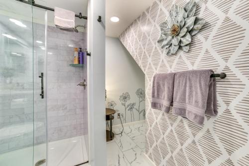 a bathroom with a shower and a towel on a wall at Luxury Lakefront Boyne City Townhome with Views! in Boyne City