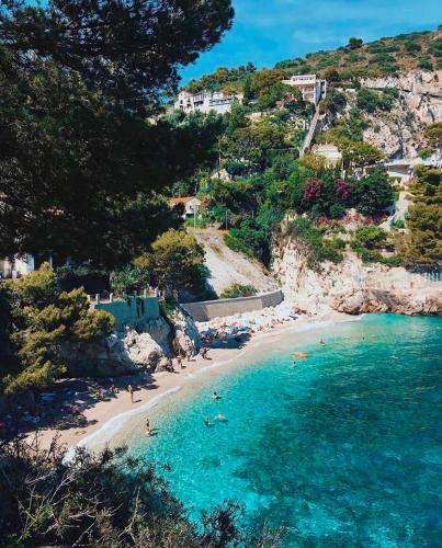 a group of people on a beach in the water at Appartement neuf coup de coeur entre Èze et Monaco in Èze