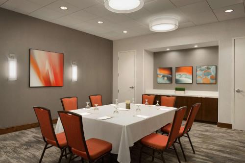 a conference room with a white table and chairs at DoubleTree by Hilton Bradley International Airport in Windsor Locks
