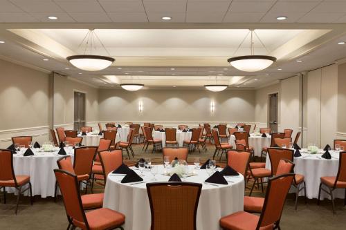 a conference room with tables and chairs and tablesktop at DoubleTree by Hilton Bradley International Airport in Windsor Locks