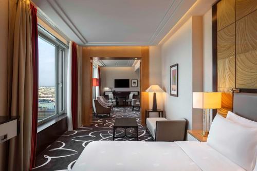 a hotel room with a bed and a living room at Waldorf Astoria Berlin in Berlin