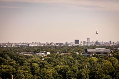 a view of a city with a tv tower in the distance at Waldorf Astoria Berlin in Berlin