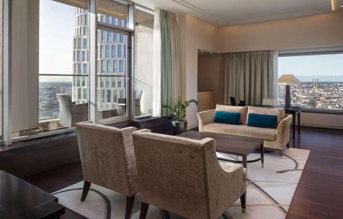a living room with a view of a building at Waldorf Astoria Berlin in Berlin