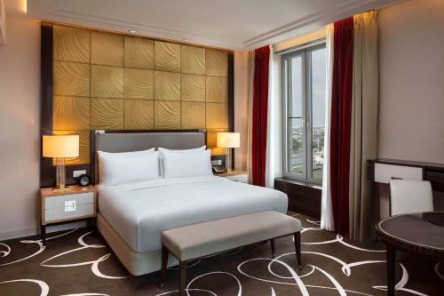 a hotel room with a bed and a window at Waldorf Astoria Berlin in Berlin