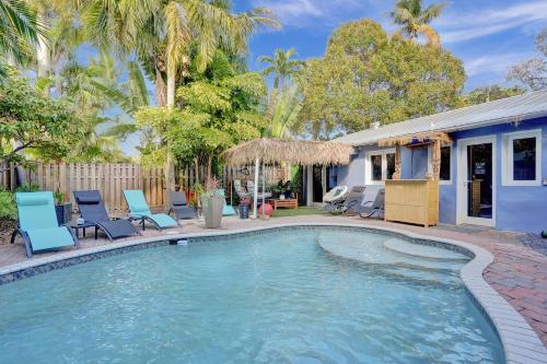a swimming pool with chairs and a house at Kiki 5 - Men's Clothing optional Guest Houses in Fort Lauderdale