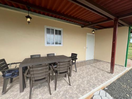 a wooden table and chairs on a patio at Hotel VILLAS DON PABLO LAS TABLAS in Las Tablas