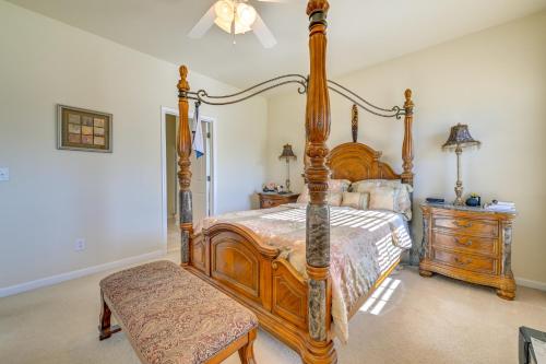 - une chambre avec un lit à baldaquin en bois et une commode dans l'établissement 6 Mi to Charlotte Motor Speedway Home with Fire Pit, à Concord