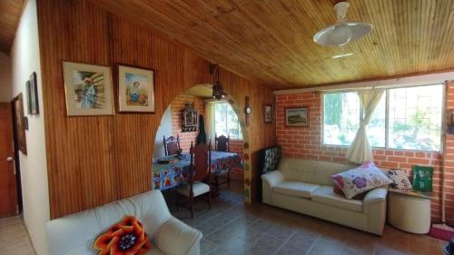a living room with two white couches and a table at country estate in Pasto