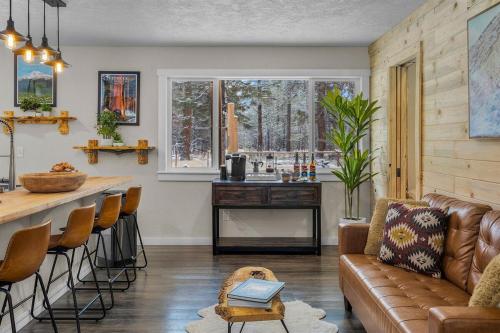 a living room with a couch and a kitchen with a counter at Hot Tub, Fire Pit, Dog Friendly, Heart of Sisters, Amenities in Sisters