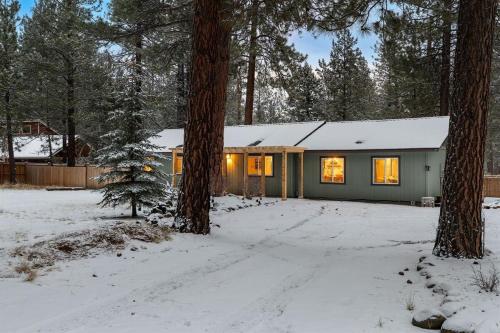 a house in the woods in the snow at Hot Tub, Fire Pit, Dog Friendly, Heart of Sisters, Amenities in Sisters