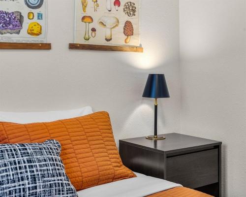 a bedroom with a bed and a table with a lamp at Hot Tub, Fire Pit, Dog Friendly, Heart of Sisters, Amenities in Sisters