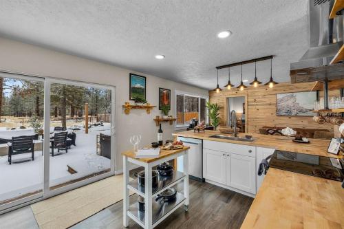 a kitchen with a counter and a dining room at Hot Tub, Fire Pit, Dog Friendly, Heart of Sisters, Amenities in Sisters