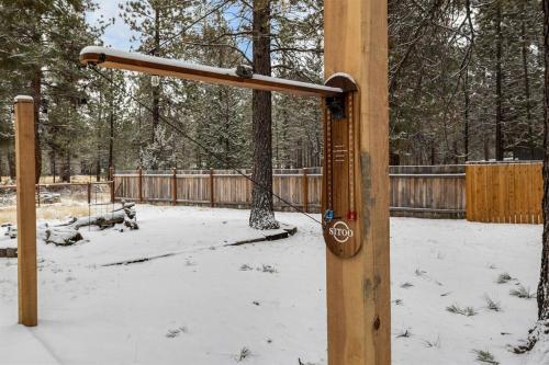a wooden pole with snow on it in a park at Hot Tub, Fire Pit, Dog Friendly, Heart of Sisters, Amenities in Sisters