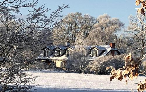 a house in a field with snow on the ground at 5 Bedroom Pet Friendly Home In Srokowo in Srokowo