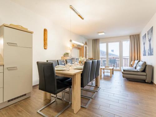 a kitchen and dining room with a table and chairs at Emma Top 2 in Dienten am Hochkönig