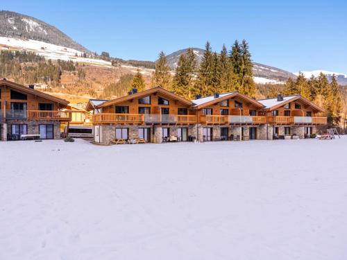 a lodge in the snow with a large snow covered field at FIIF Pinzgau in Wald im Pinzgau